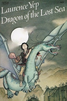Cover of Dragon of the Lost Sea, by Laurence Yep, featuring a pale greenish-grey dragon, with an Asiatic youth with baggage on its back, flying at night with clouds in the sky and the moon in the background, and mountains and trees below.