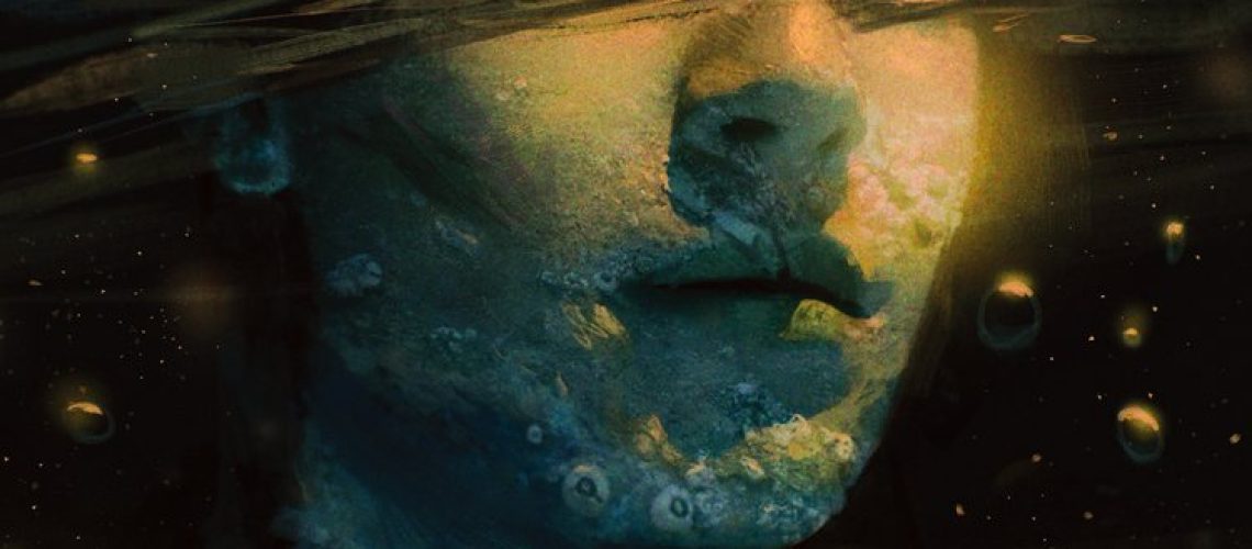 Cover of From the Belly by Emmett Nahil, featuring an underwater view of a mostly submerged androgynous person, with indeterminate blobs floating in the water.